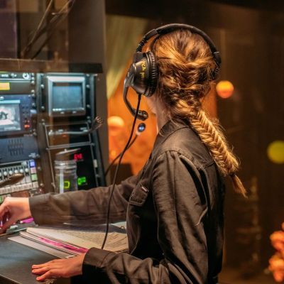 Photo of student backstage managing lighting